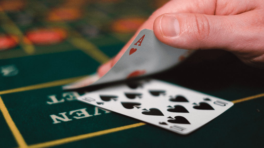 A person playing blackjack at a casino table.