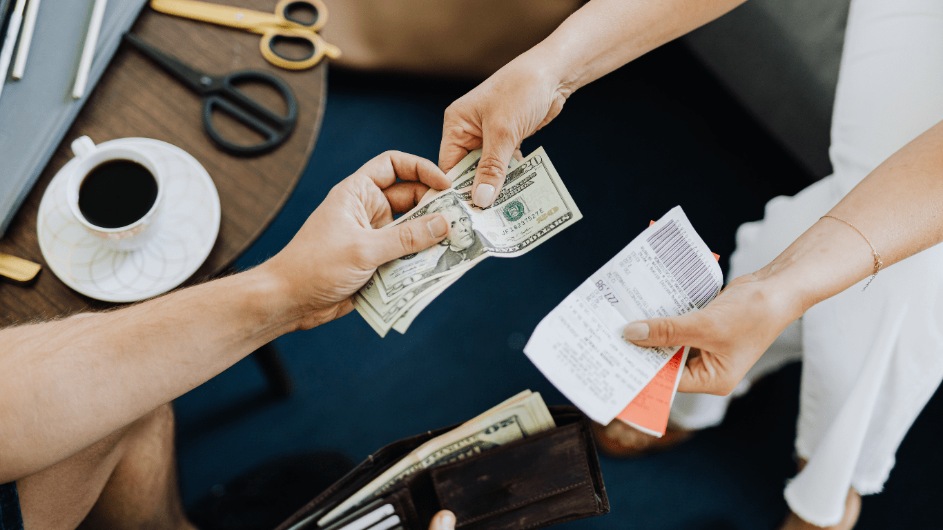 two people handing money to each other