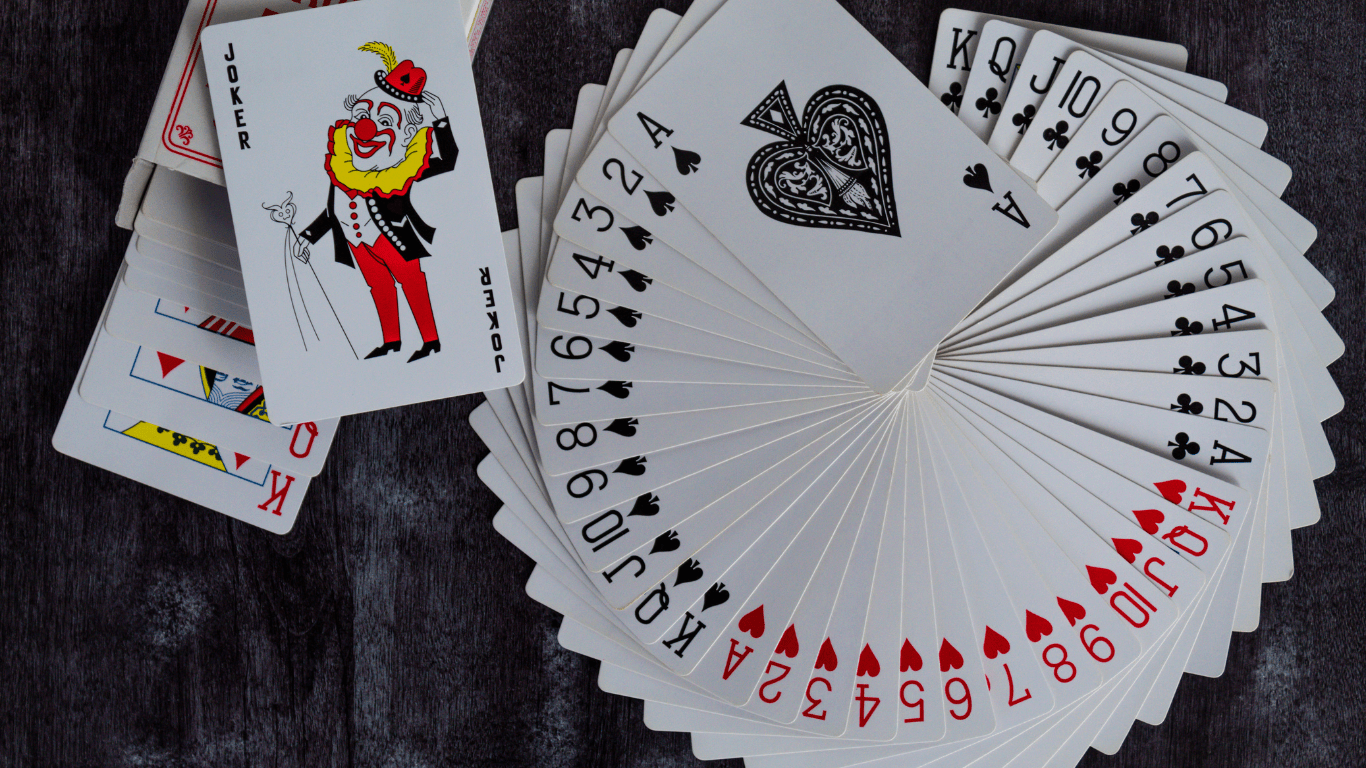 a deck of playing cards sitting on top of a wooden table