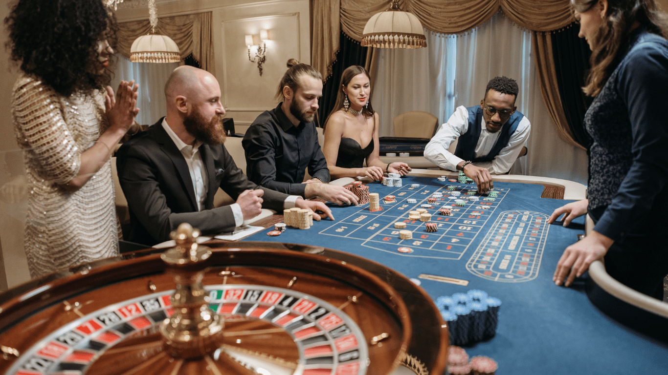 a group of people playing roulette at a casino table