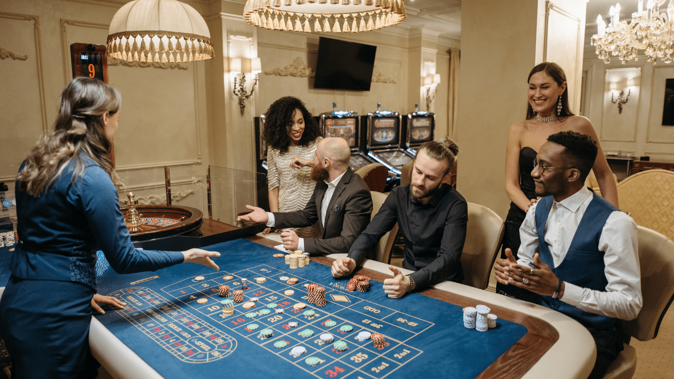 a group of people playing roulette at a casino