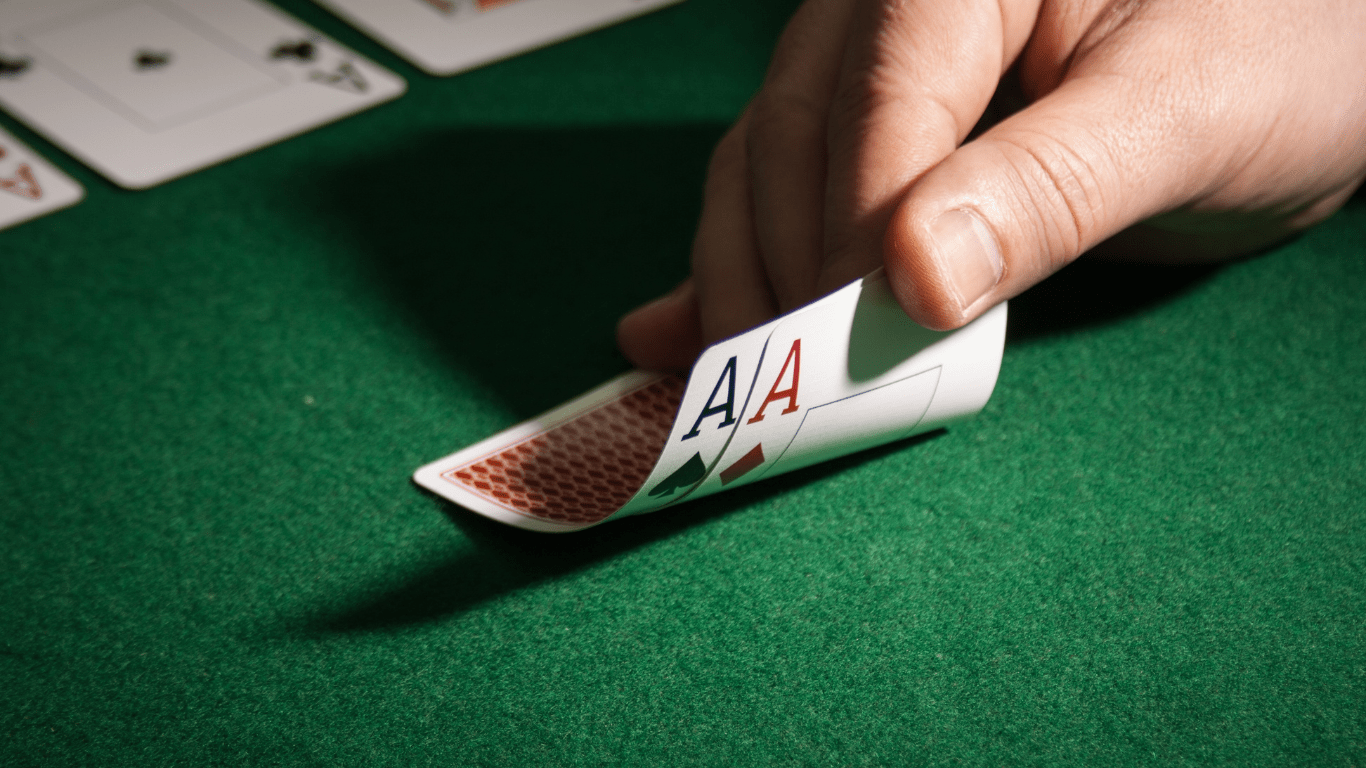 a person holding a playing cards