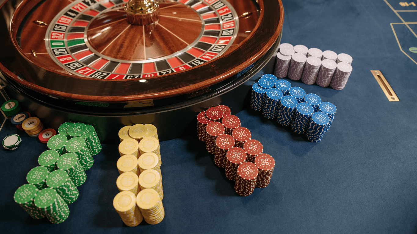 an image of a casino table with chips and a roulette wheel