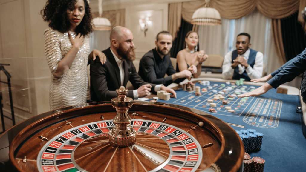 a group of people playing roulette at a casino table