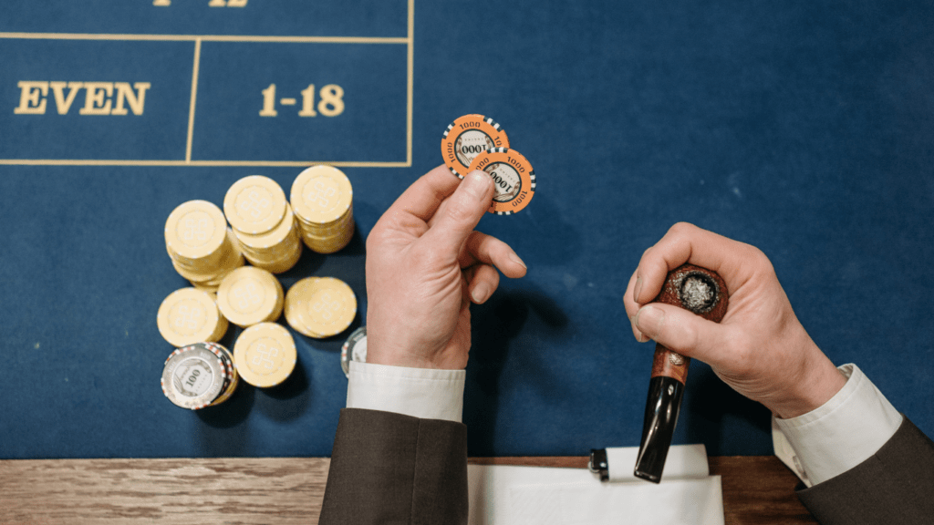 a person holding a casino chips