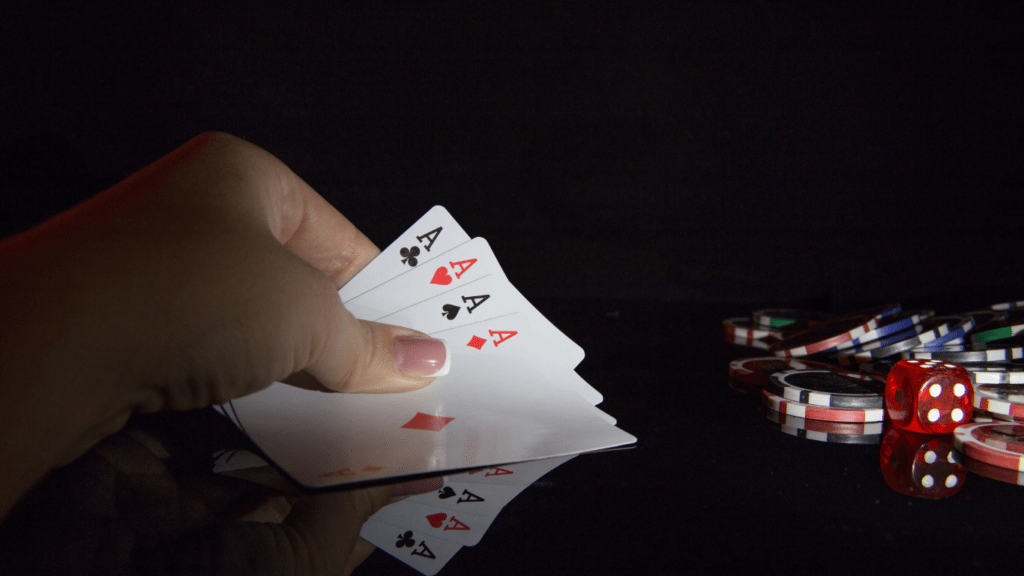 a person holding a playing cards