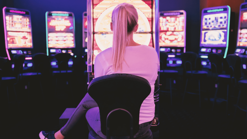 a person playing a slot machine at night