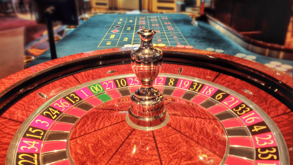 an image of a casino table with chips and a roulette wheel