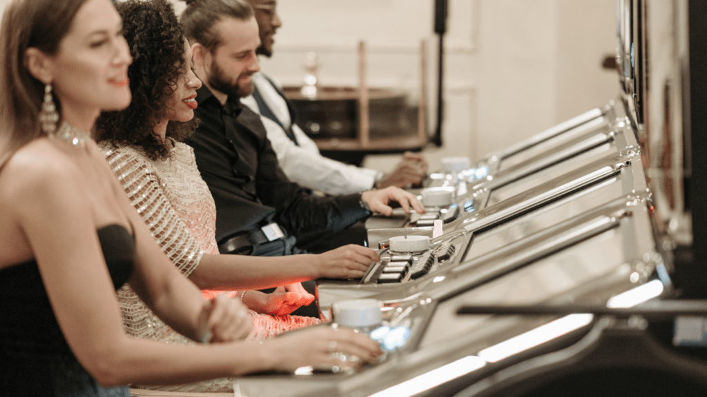 two men sitting in front of slot machines in a casino