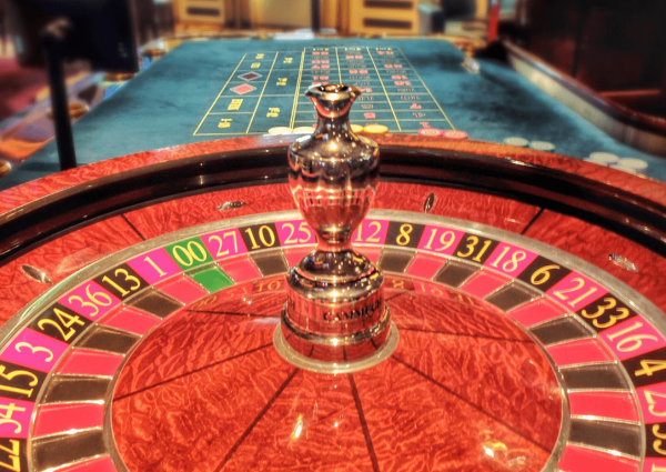 an image of a casino table with chips and a roulette wheel